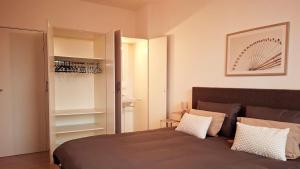 a bedroom with a large bed and a closet at Apartment with skyline view in Eindhoven