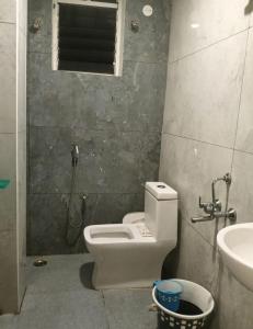 a bathroom with a toilet and a sink at HoTEL MADHAVI ELITE in Vijayawāda +36 photos