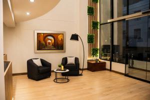 a lobby with two chairs and a table in a building at BRIX Hotel in Arequipa