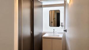 a bathroom with a sink and a mirror at April Ari-Saphankhwai in Bangkok