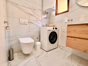 a bathroom with a washing machine and a toilet at Kuća za odmor Bruna in Livno +19 photos