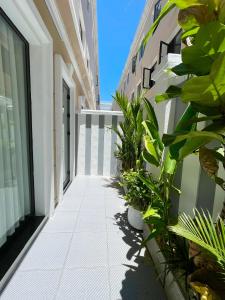 a corridor of a building with plants on the side at Vin Luxury Hotel in Quang Tri +29 photos