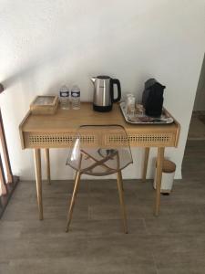 a wooden table with a coffee maker on top of it at Pigeonnier La Carole 35m2 in Monlezun