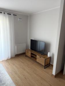 a living room with a flat screen tv on a dresser at Apartament Bald1 in Kąty Wrocławskie +5 photos