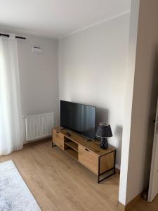 a living room with a flat screen tv on a stand at Apartament Bald1 in Kąty Wrocławskie