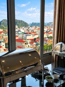 a kitchen with a view of a city from a window at Royal ANAN Hotel in Ninh Binh