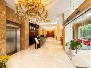 a large lobby with a chandelier and a hallway at Royal ANAN Hotel in Ninh Binh