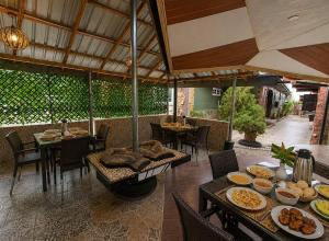 a restaurant with a table with plates of food at Immanuel Victory Hotel & Restaurant in Ajenkotoku