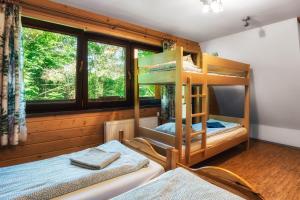 two bunk beds in a room with a window at Ski House Szczyrk - Solisko in Szczyrk