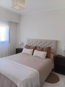 a bedroom with a large white bed with two lamps at Ayres Apart in Chivilcoy