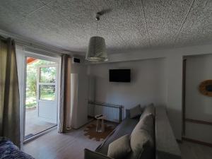 a living room with a couch and a sliding glass door at Jakov & David in Gospić
