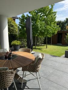 a wooden table and chairs on a patio at Luxuriöse Fewo Schaffner in Warendorf