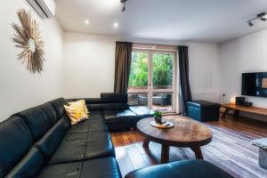 a living room with a couch and a table at Ski House Szczyrk - Centrum in Szczyrk