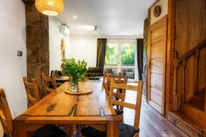 a dining room with a wooden table and chairs at Ski House Szczyrk - Centrum in Szczyrk