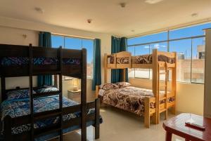 a room with two bunk beds and a window at Depawanka 2 in Huancayo