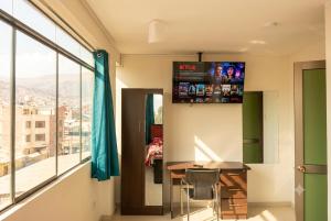 a room with a table and a large window at Depawanka 2 in Huancayo