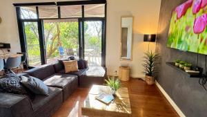 a living room with a couch and a table at Nature Resort Villas - Villas with a View in Cowes