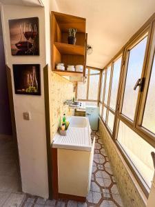 a small kitchen with a sink and some windows at Wayra Glider Norma Centro in Norma +18 photos