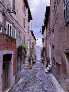 an alley with buildings and a cobblestone street at Wayra Glider Norma Centro in Norma