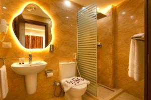 a bathroom with a toilet and a sink and a shower at Tropitel Pyramids View Hotel in Cairo +82 photos