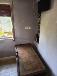 a room with a bench in a room with a window at Petit cocon in Laignes +8 photos