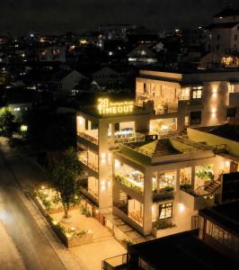 a night view of a building with the time out sign on it at TimeOut Dalat Boutique Hotel in Khu Chi Lăng