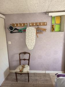 a chair sitting in a room with a wall at Petit cocon in Laignes