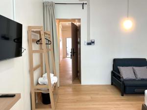 a living room with a ladder and a couch at April Ari-Saphankhwai in Bangkok