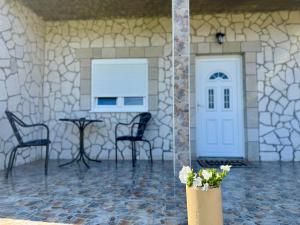 a room with a white door and chairs and a table at A&A Durmitor Apartments in Žabljak +18 photos