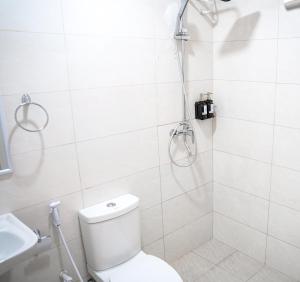 a bathroom with a shower with a toilet and a sink at Naeco Select Pearl in Hanimaadhoo +41 photos