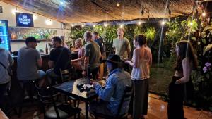 a group of people standing in a bar at Costa Rica Backpackers in San José +125 photos