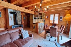 a living room with a couch and a table at Chalets Shangrila in Saint-Michel-de-Chaillol