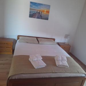 a bedroom with a bed with two towels on it at Makri Vacation House in Alexandroupoli
