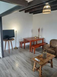 a living room with a couch and a table at Maison proche château in Bressuire