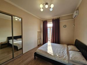 a bedroom with a bed and a large mirror at Майдан in Kyiv