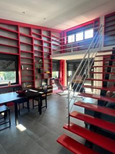 a dining room with red walls and a staircase at Blanca Mañana in Ribeira