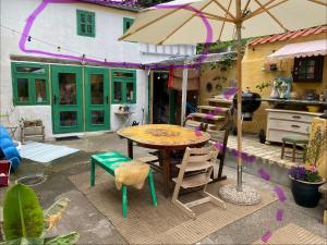 a patio with a table and chairs and an umbrella at Casa Ricardo in Svendborg
