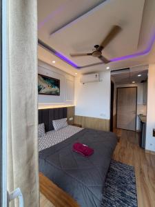 a bedroom with a bed and a ceiling with purple lights at The heaven stay in Greater Noida