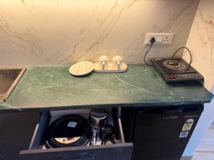 a kitchen counter with a counter top with a dishwasher at The heaven stay in Greater Noida