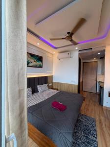 a bedroom with a bed with a red bag on it at The heaven stay in Greater Noida