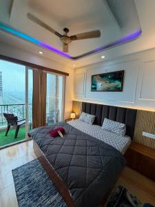 a bedroom with two beds and a ceiling fan at The heaven stay in Greater Noida