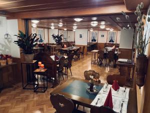 a restaurant with tables and chairs in a room at Traube Restaurant & Hotel in Appenzell