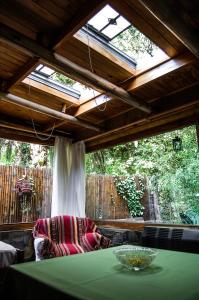 a room with a green table and a large window at Cabaña La Strega in Tandil