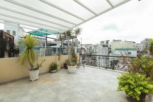 a balcony with potted plants on top of a building at Homestay Beauty D1 in Ho Chi Minh City