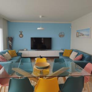 a living room with a couch and a table and chairs at Casa Lily in Caleta De Fuste
