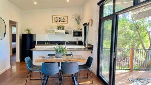 a kitchen and dining room with a table and chairs at Nature Resort Villas - Villas with a View in Cowes +76 photos