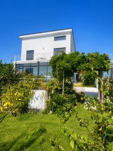 a white house with trees in front of it at Blanca Mañana in Ribeira