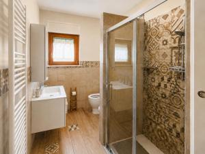 a bathroom with a shower and a sink and a toilet at Smart Suite at Villa Anna - Bike Friendly in Buonconvento +19 photos