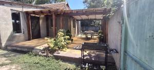 a wooden pergola with a table and chairs on a patio at Gastehaus in Kostyantynivka