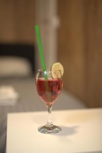a drink in a glass with a green straw at The Lemon House in Tel Aviv